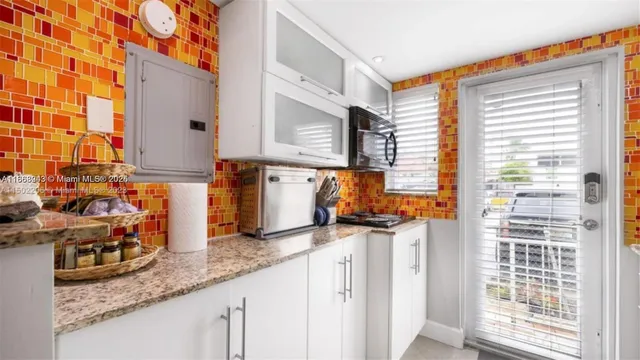 a kitchen with stainless steel appliances granite countertop a sink and a wooden cabinets