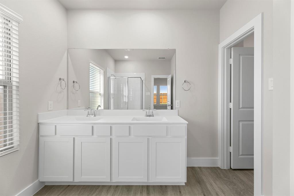 2372 Bell Way Forney, TX 75126 - Photo 19 of 39 a spacious bathroom with a granite countertop sink and a mirror