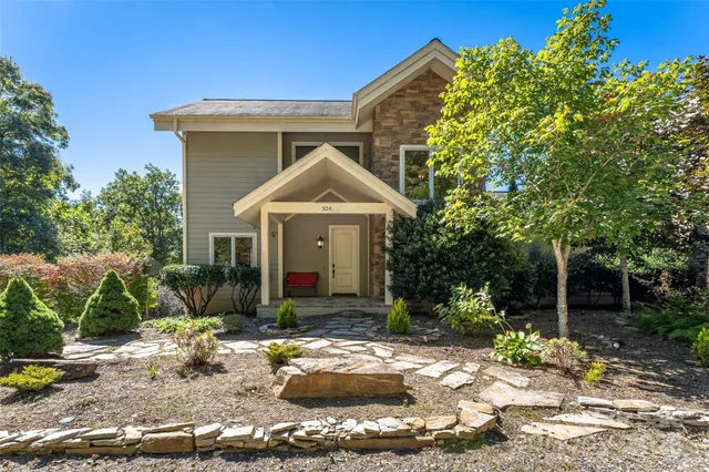 a front view of a house with garden