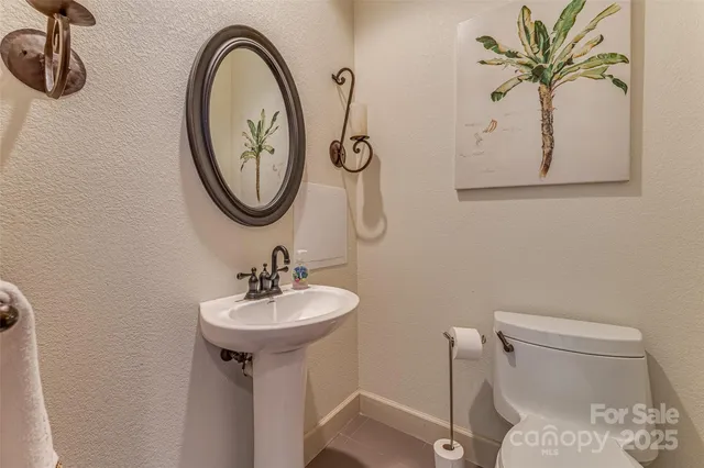 a bathroom with a toilet a sink and a mirror