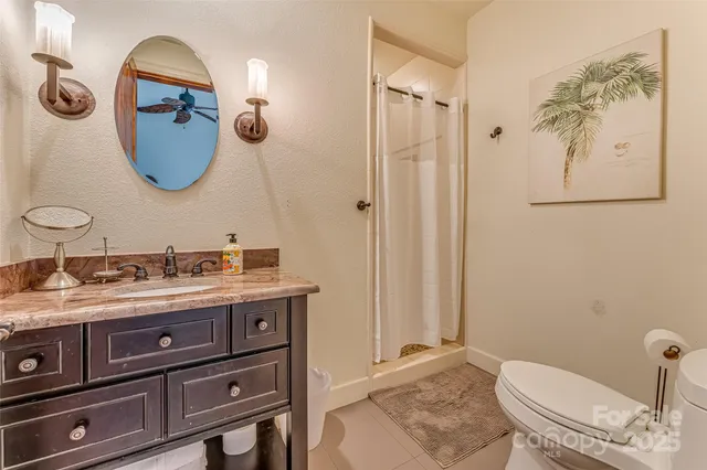 a bathroom with a toilet a sink and mirror
