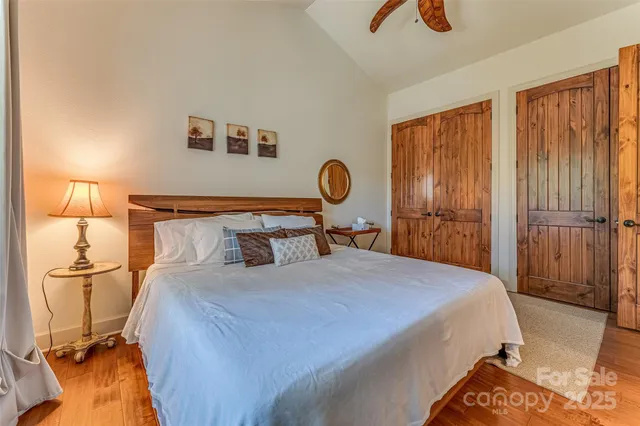 a bedroom with a bed and dresser with mirror