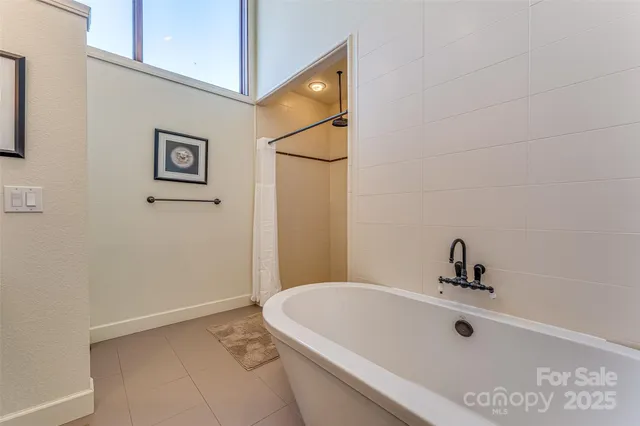 a bathroom with a tub and shower