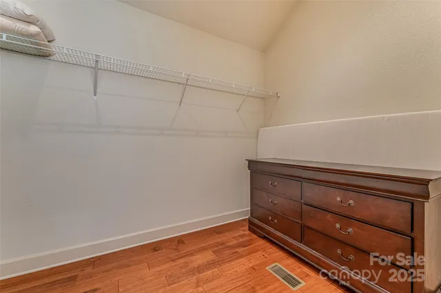 a view of room with wooden floor