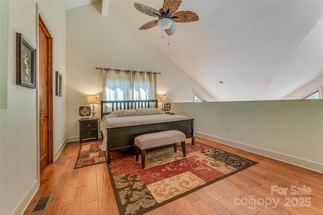a bedroom with furniture and a rug