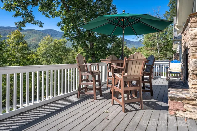 a view of balcony with wooden floor and outdoor seating