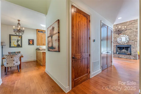 a view of a hallway with furniture and wooden floor