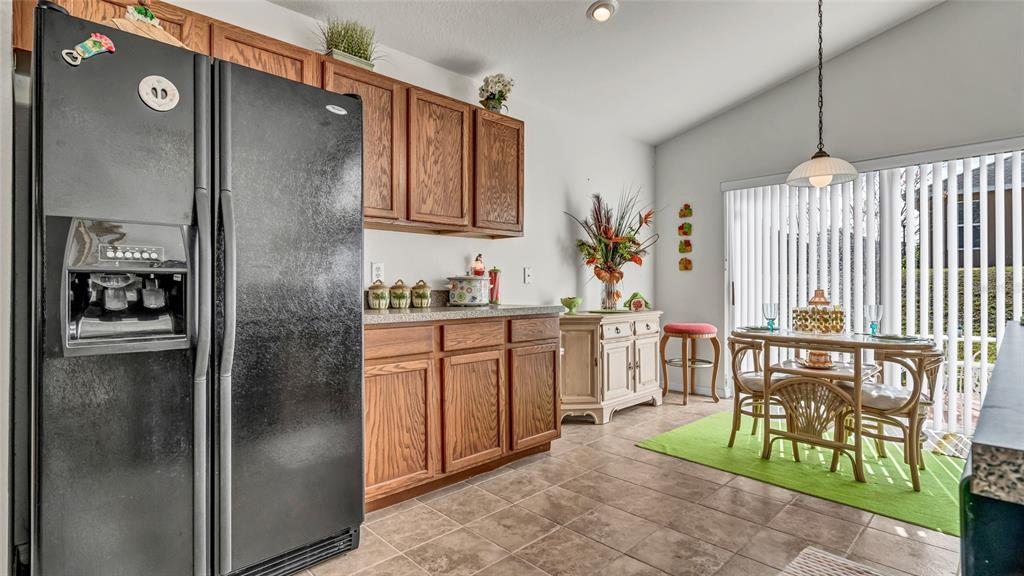 1153 Legatto Loop Dundee, FL 33838 - Photo 14 of 48 a kitchen with stainless steel appliances granite countertop a refrigerator and a stove