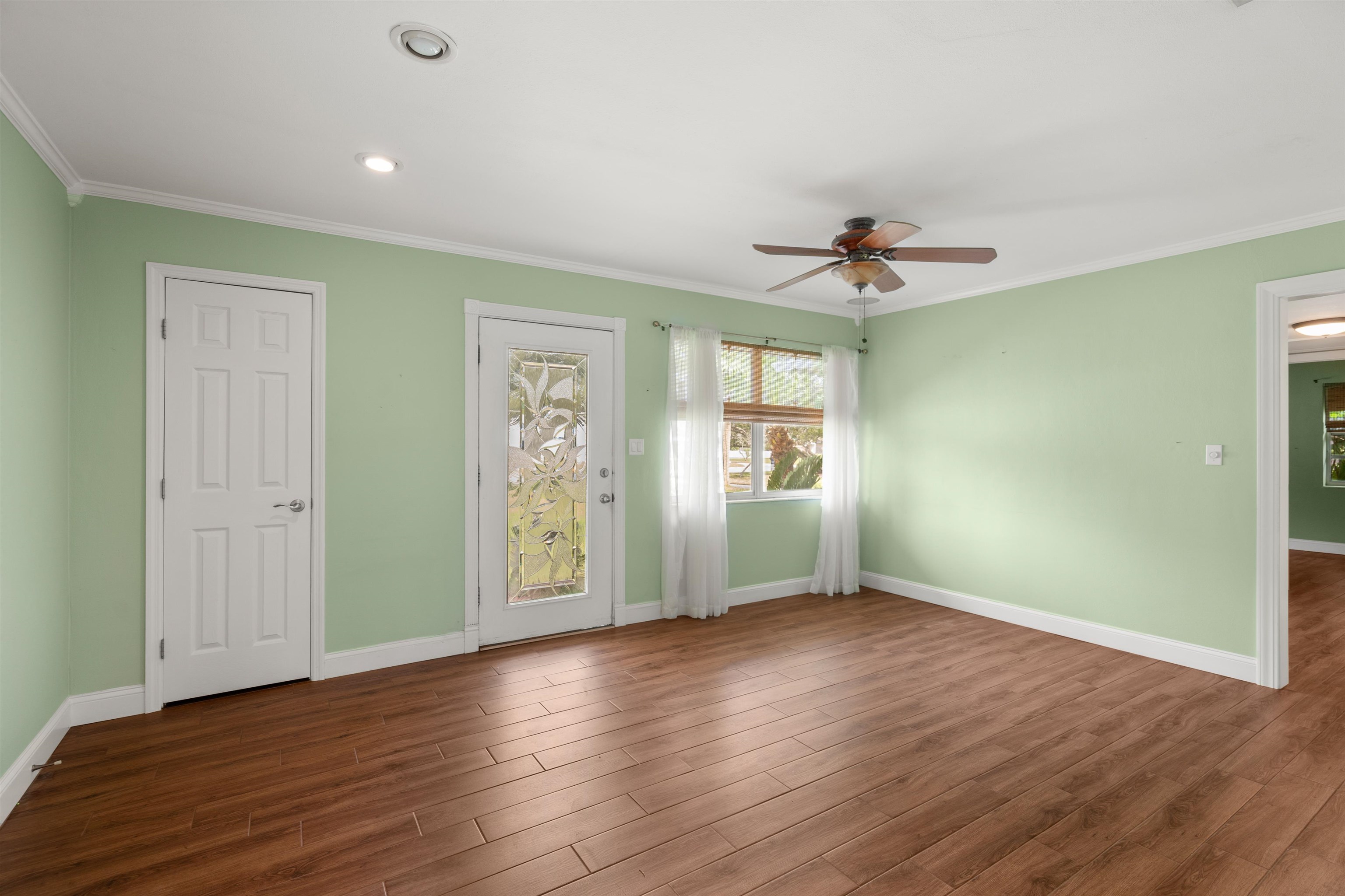 146 Menendez Road St. Augustine, FL 32080 - Photo 11 of 39 wooden floor in an empty room with a window
