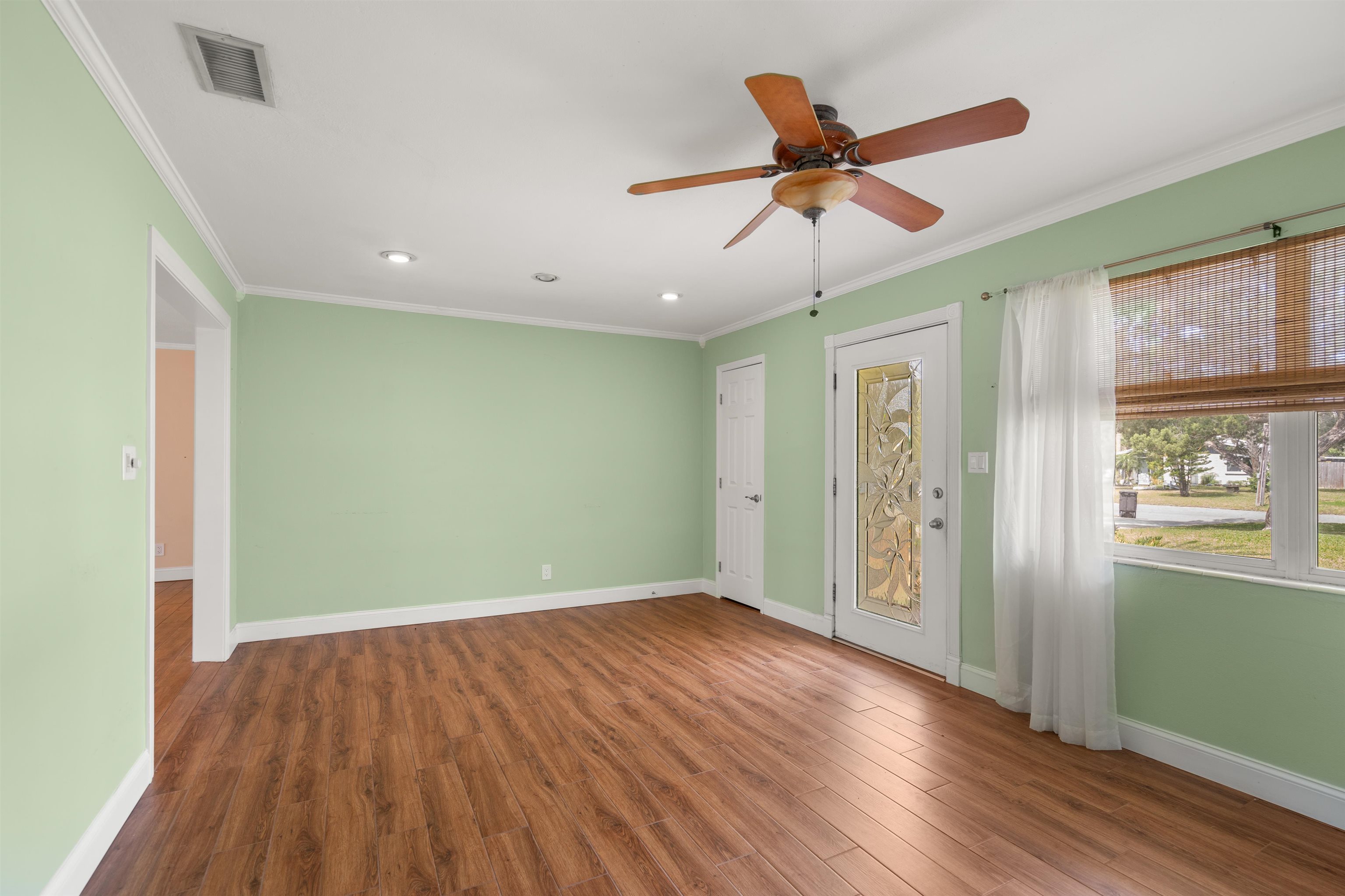 146 Menendez Road St. Augustine, FL 32080 - Photo 12 of 39 a view of an empty room with wooden floor and a window