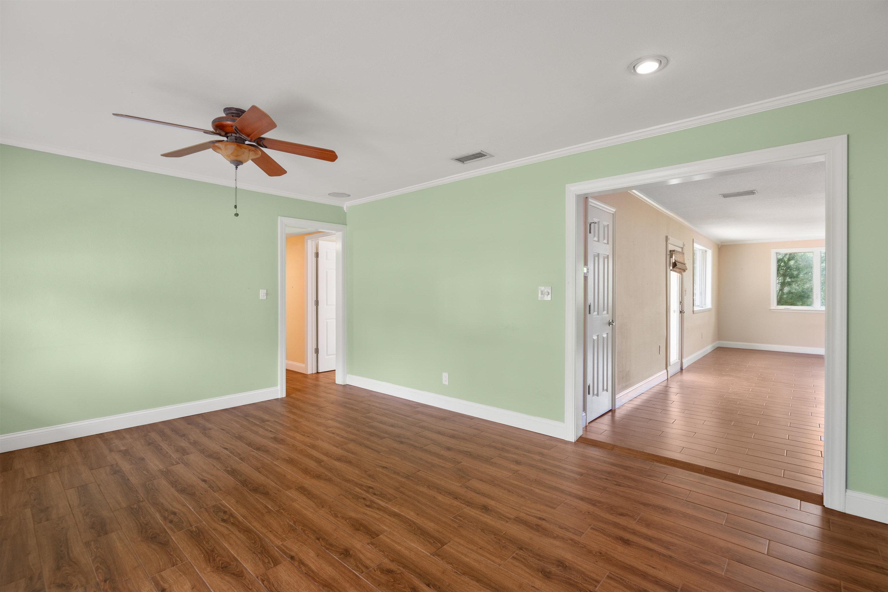 146 Menendez Road St. Augustine, FL 32080 - Photo 13 of 39 wooden floor in an empty room with a window