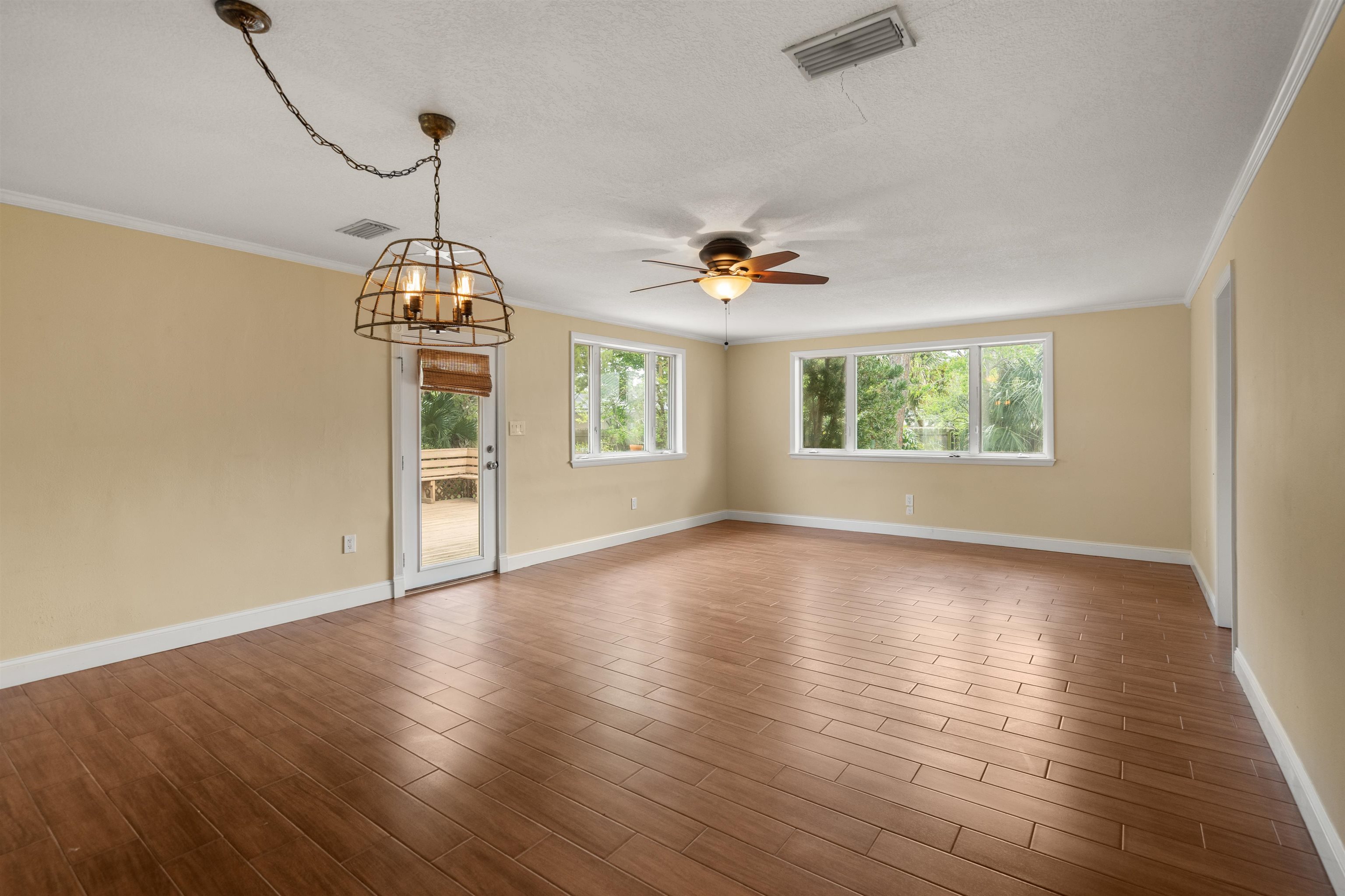 146 Menendez Road St. Augustine, FL 32080 - Photo 14 of 39 a view of an empty room with wooden floor and a window