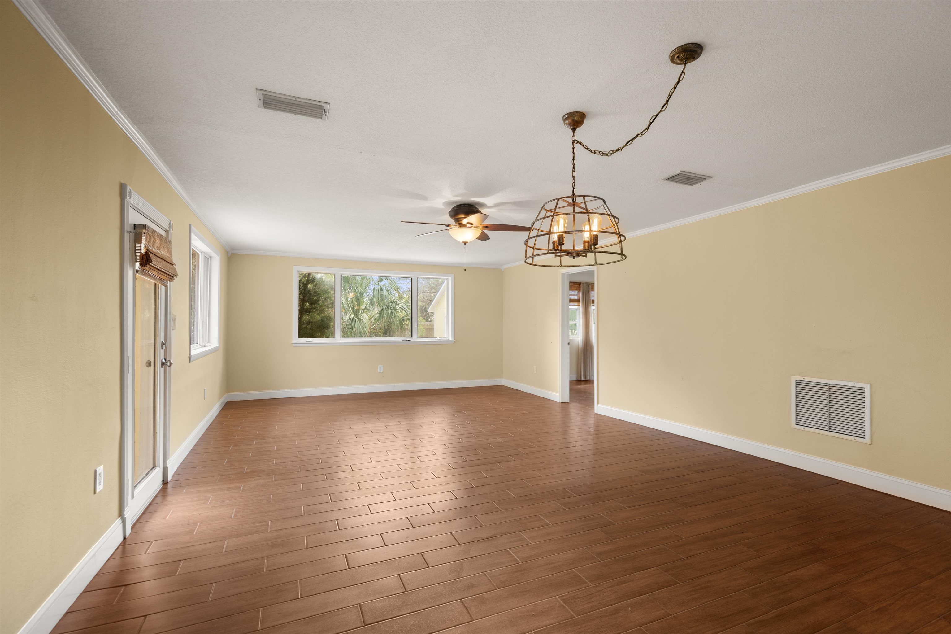 146 Menendez Road St. Augustine, FL 32080 - Photo 15 of 39 a view of an empty room with wooden floor and a window