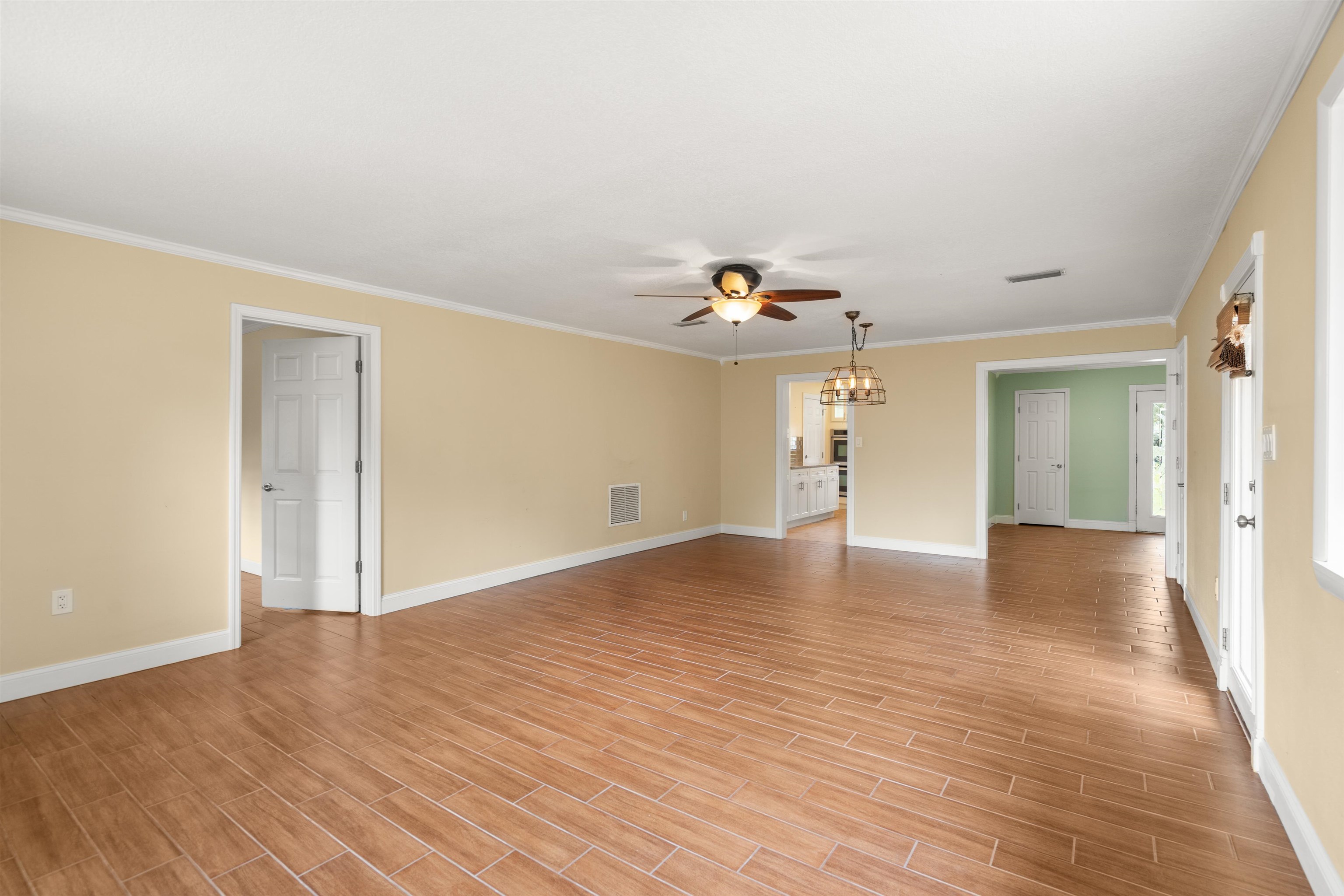 146 Menendez Road St. Augustine, FL 32080 - Photo 16 of 39 a view of an empty room with wooden floor and a window