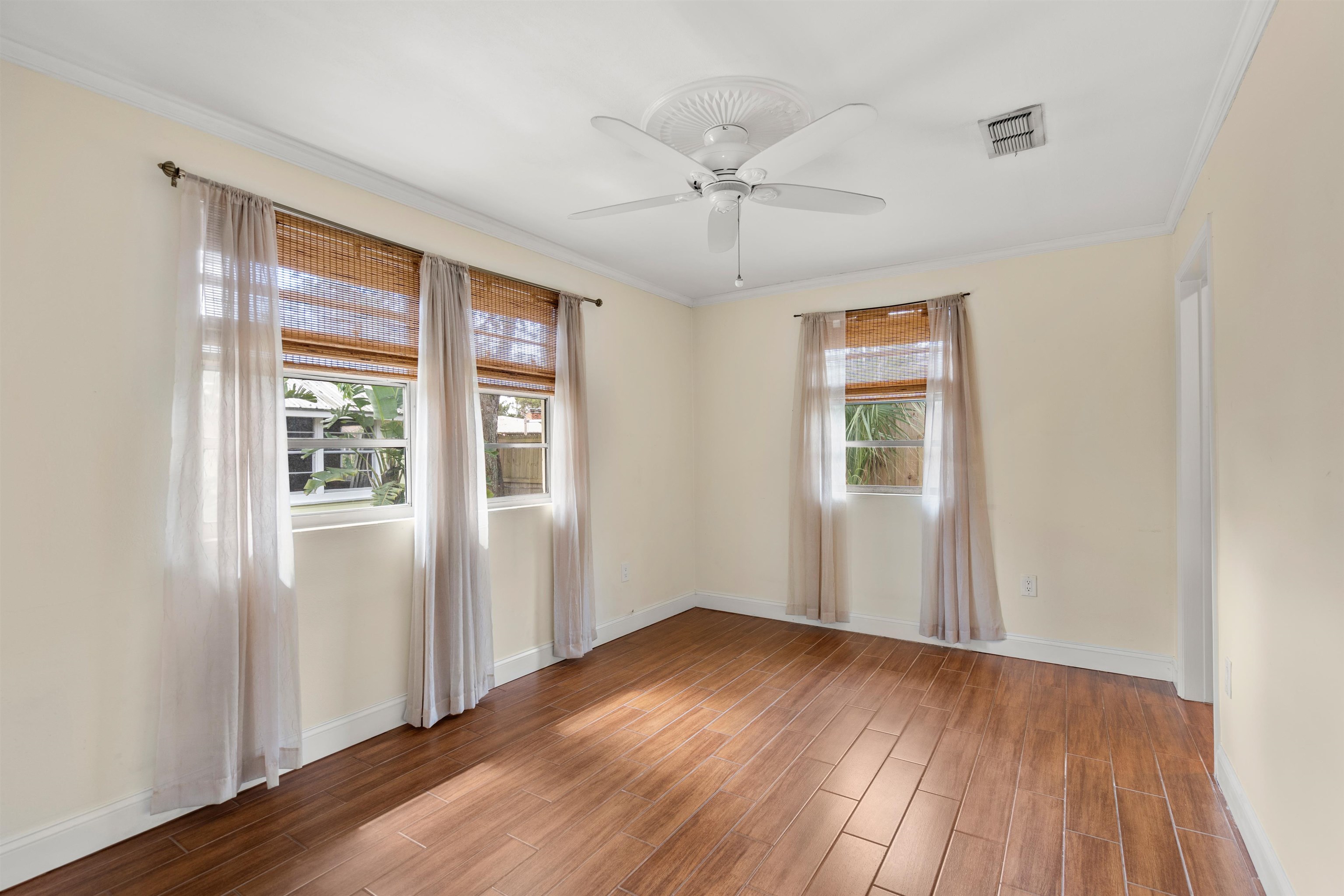 146 Menendez Road St. Augustine, FL 32080 - Photo 19 of 39 a view of an empty room with wooden floor and a window