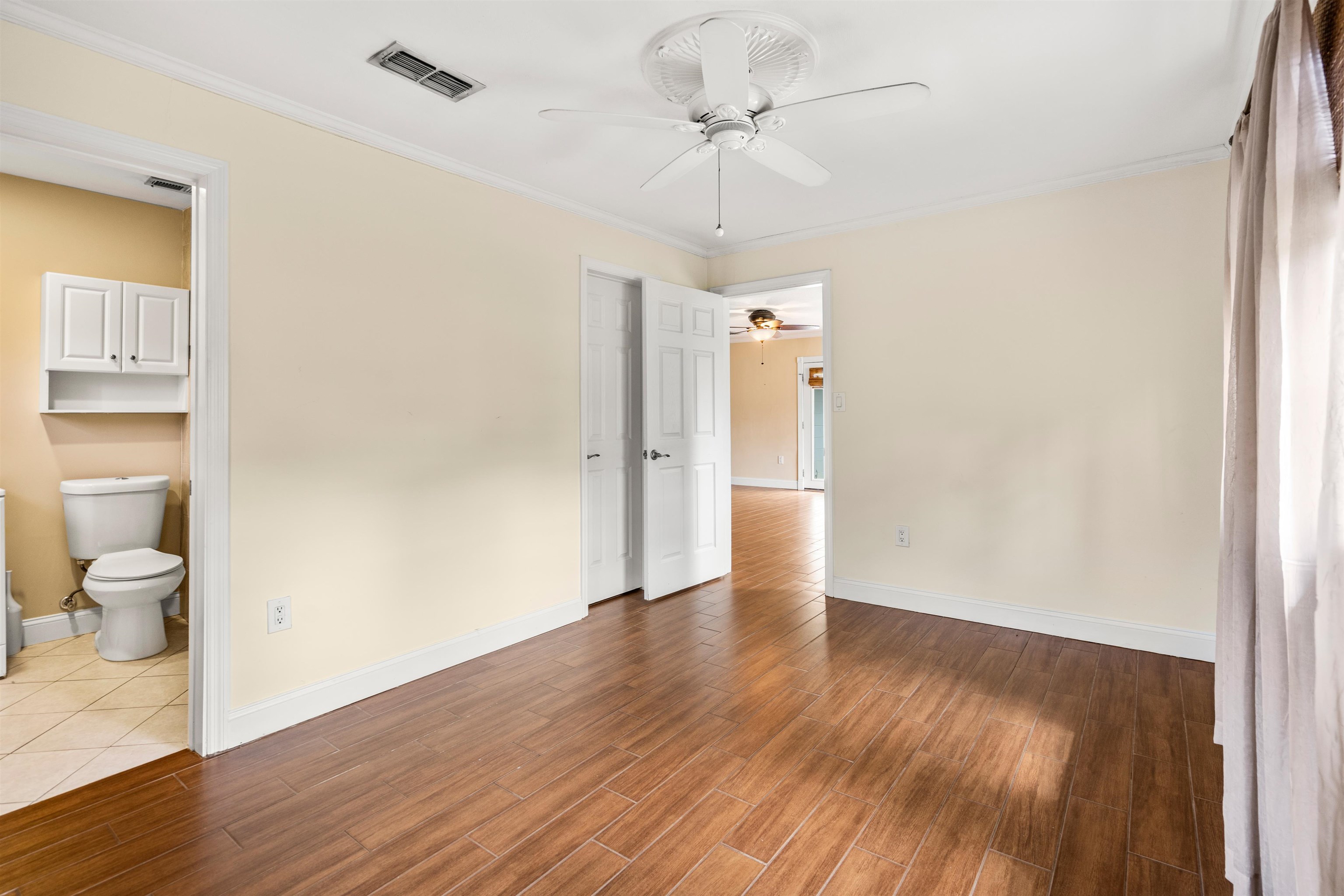 146 Menendez Road St. Augustine, FL 32080 - Photo 20 of 39 a view of a hallway with wooden floor and a bathroom