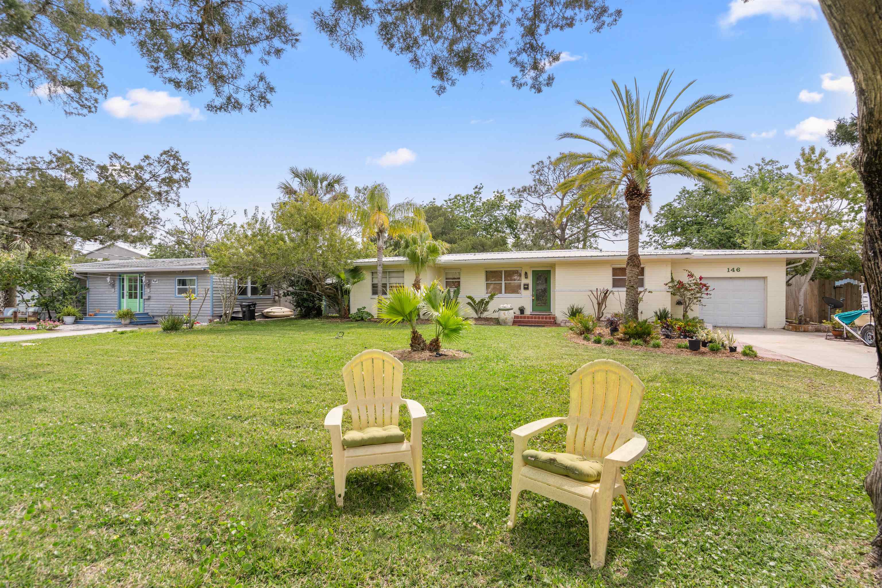 146 Menendez Road St. Augustine, FL 32080 - Photo 2 of 39 a house view with a seating space and garden