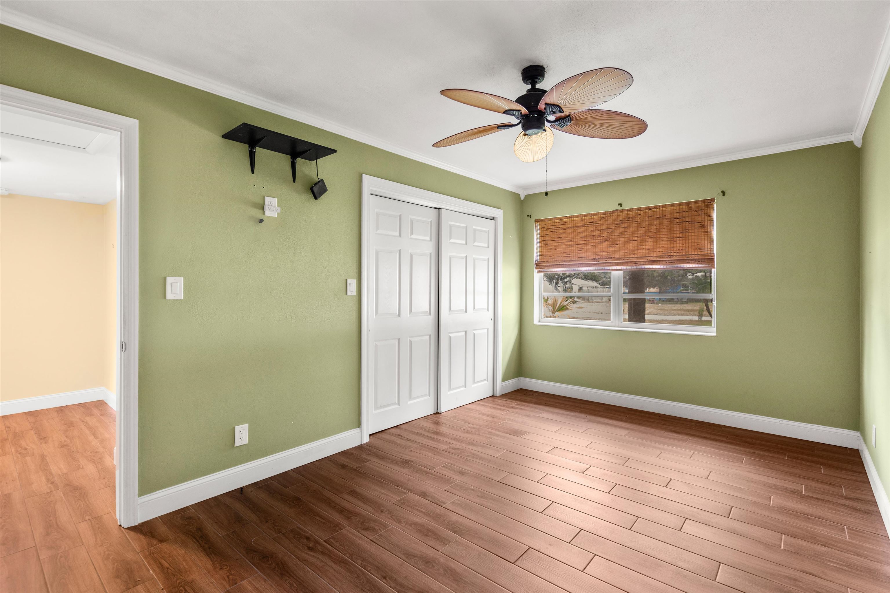 146 Menendez Road St. Augustine, FL 32080 - Photo 23 of 39 a view of an empty room with wooden floor and a window