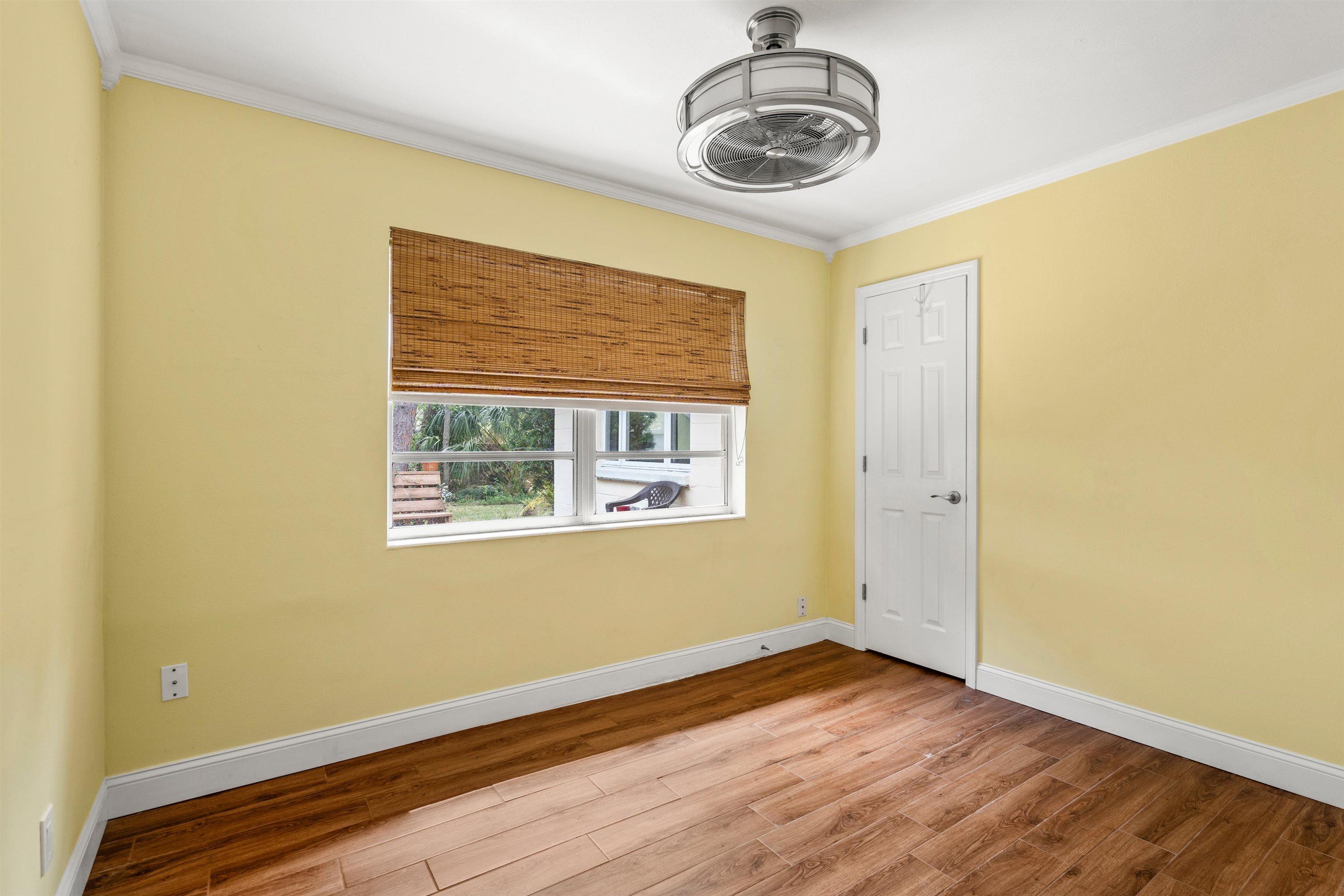 146 Menendez Road St. Augustine, FL 32080 - Photo 27 of 39 a view of an empty room with wooden floor and a window