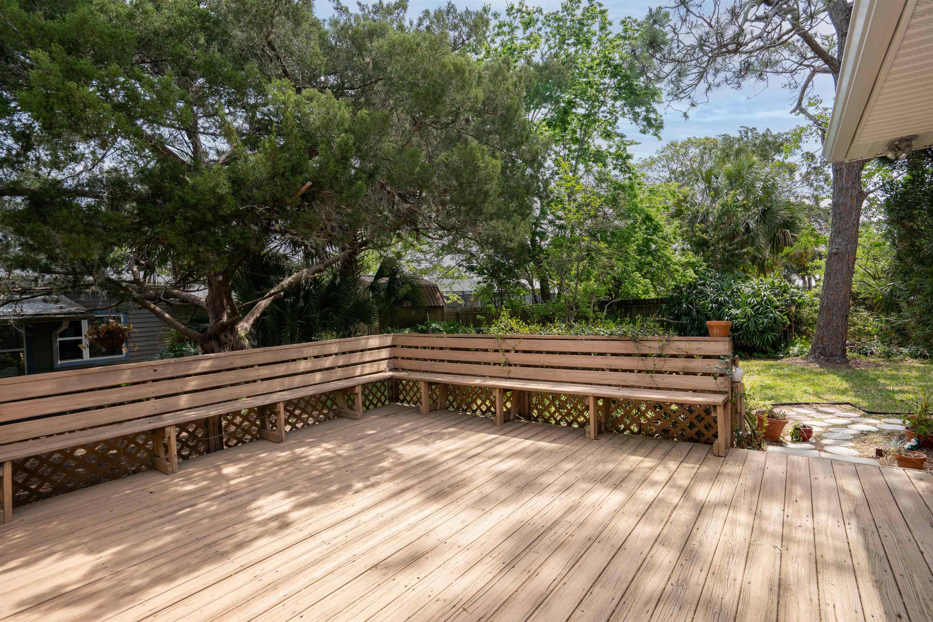 146 Menendez Road St. Augustine, FL 32080 - Photo 5 of 39 a backyard view with a wooden floor and fence