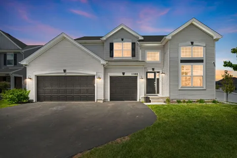 a front view of a house with a yard and garage