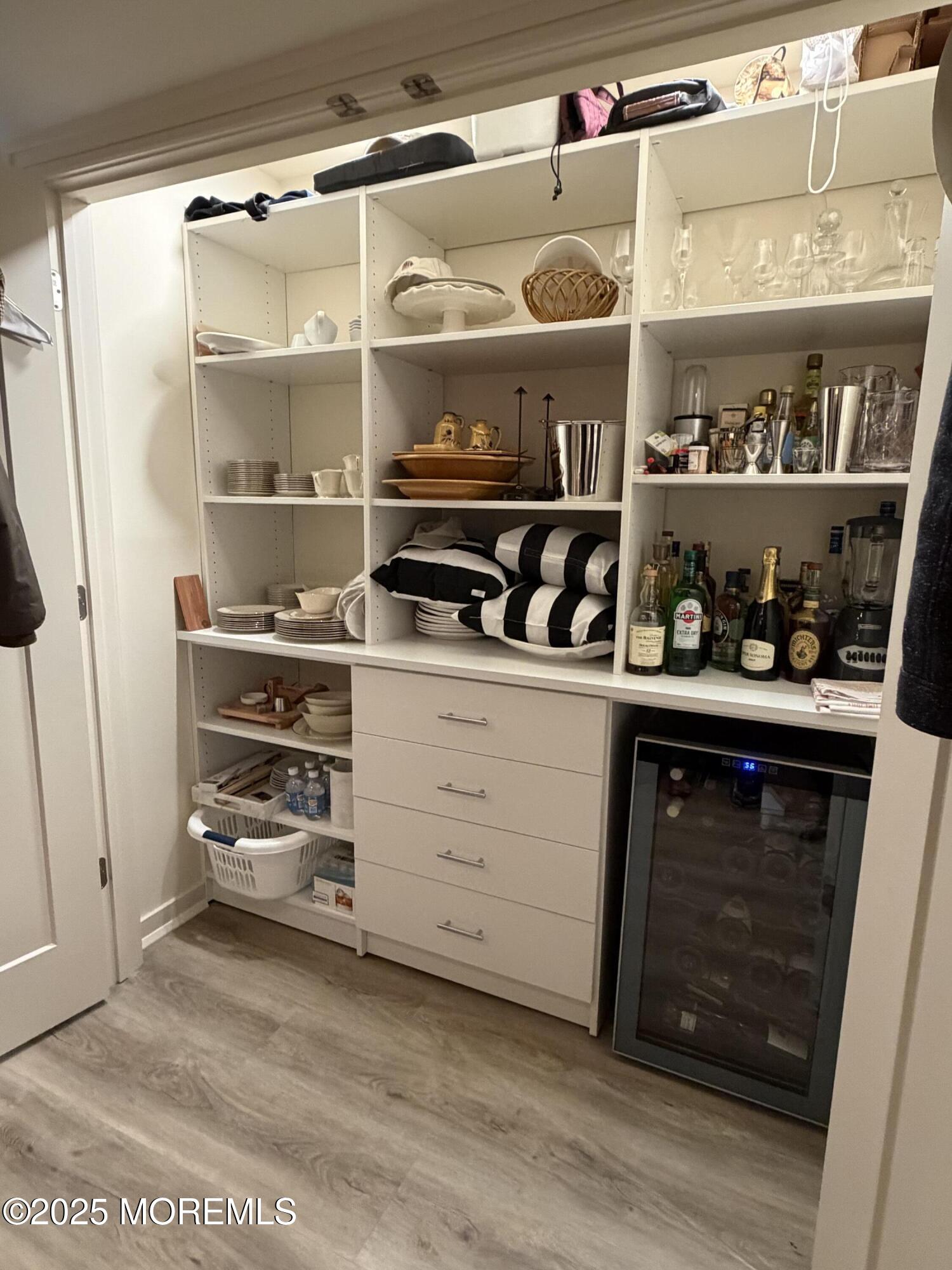23 Locust Way Spring Lake Heights, NJ 07762 - Photo 12 of 57 a kitchen with white cabinets and a wooden floor