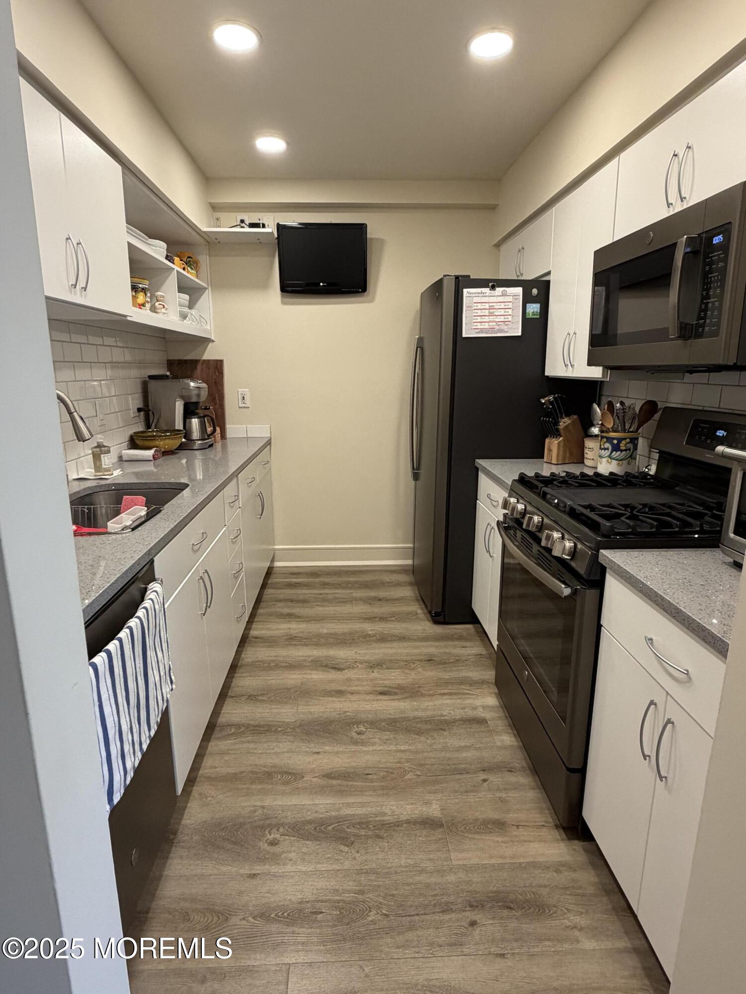23 Locust Way Spring Lake Heights, NJ 07762 - Photo 15 of 57 a kitchen with stainless steel appliances granite countertop a refrigerator a stove and a sink