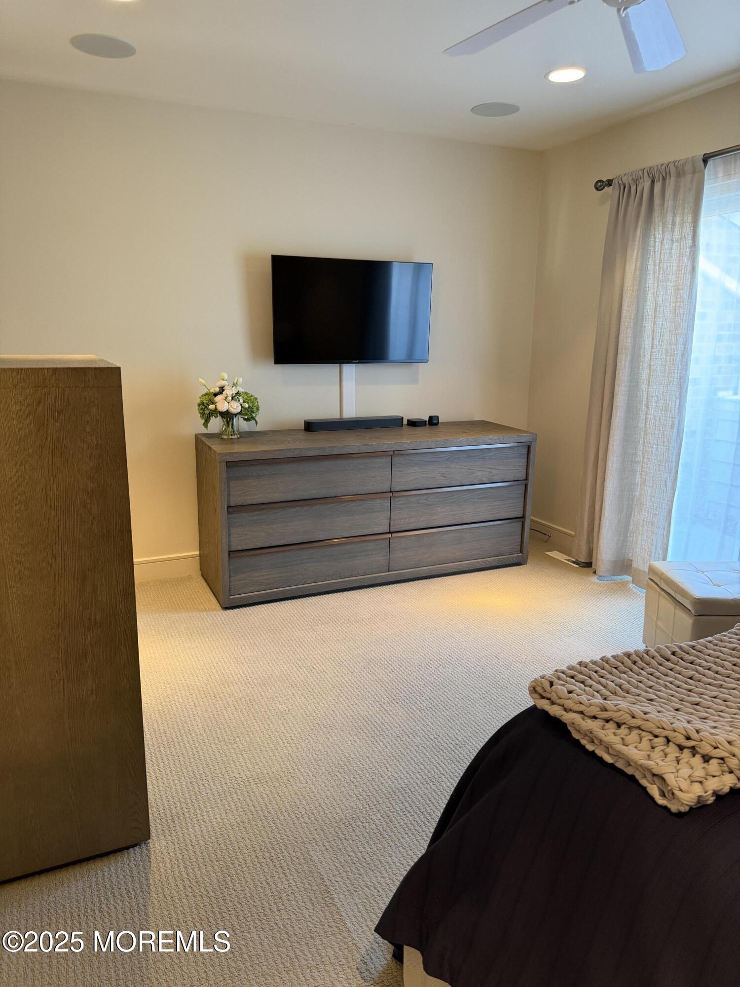 23 Locust Way Spring Lake Heights, NJ 07762 - Photo 32 of 57 a bed room with a bed tv and a mirror