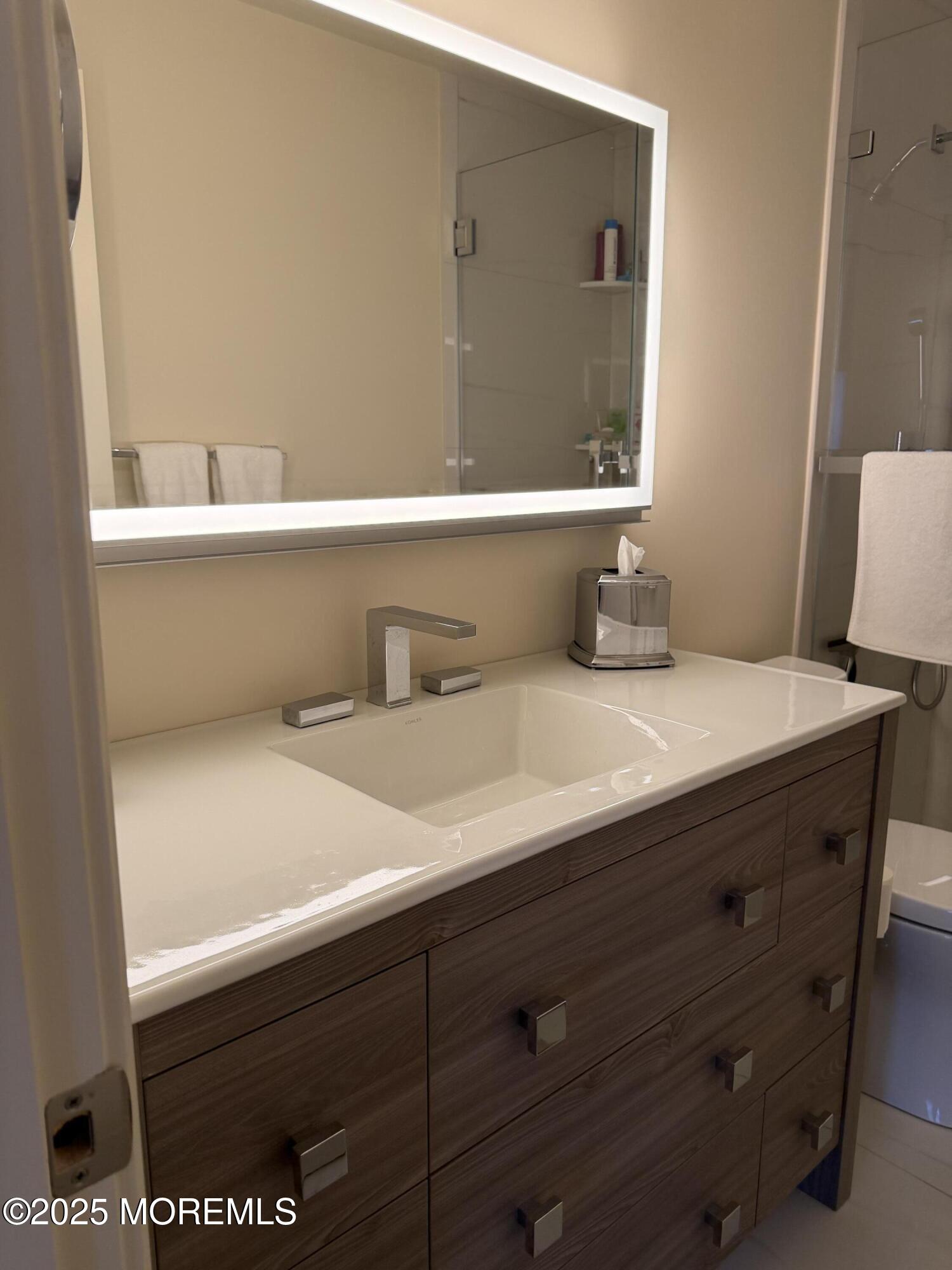 23 Locust Way Spring Lake Heights, NJ 07762 - Photo 50 of 57 a bathroom with a sink and a mirror