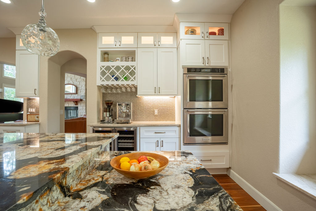 13800 Lone Rider Trail Austin, TX 78738 - Photo 8 of 27 a kitchen with stainless steel appliances a stove top oven and cabinets