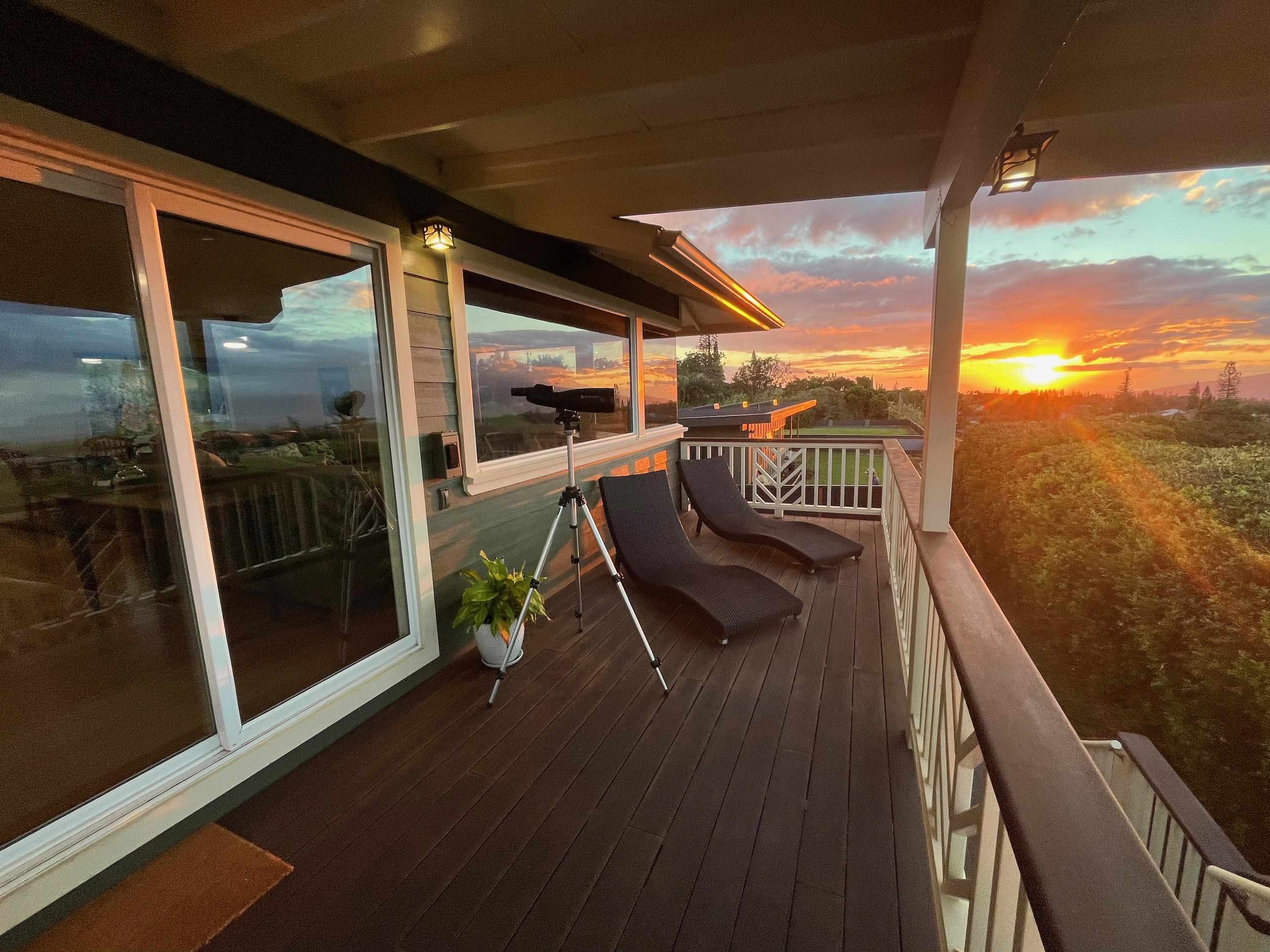 a view of a balcony with floor to ceiling windows with wooden floor