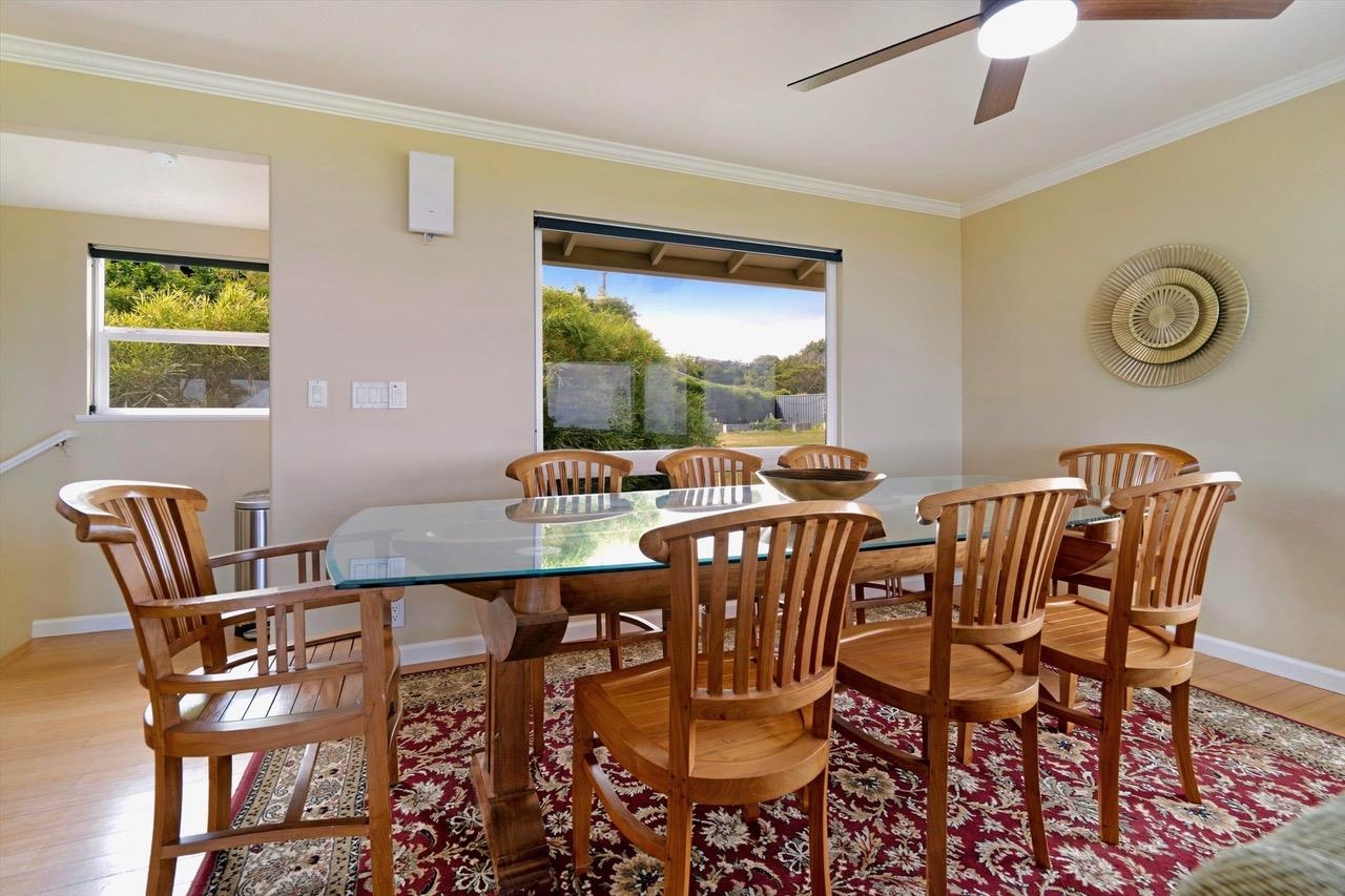1115 Pookela Road Makawao, HI 96768 - Photo 13 of 37 a dining room with furniture a window and a chandelier