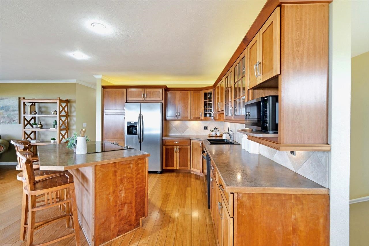 1115 Pookela Road Makawao, HI 96768 - Photo 14 of 37 a living room with stainless steel appliances kitchen island lots of furniture and chandelier