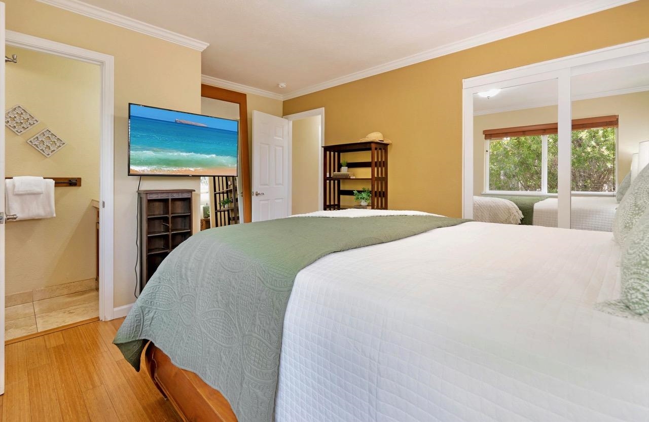 1115 Pookela Road Makawao, HI 96768 - Photo 19 of 37 a spacious bedroom with a bed and a large window