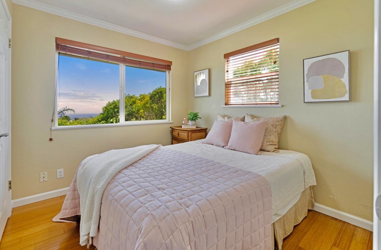 1115 Pookela Road Makawao, HI 96768 - Photo 21 of 37 a bedroom with a bed and a window