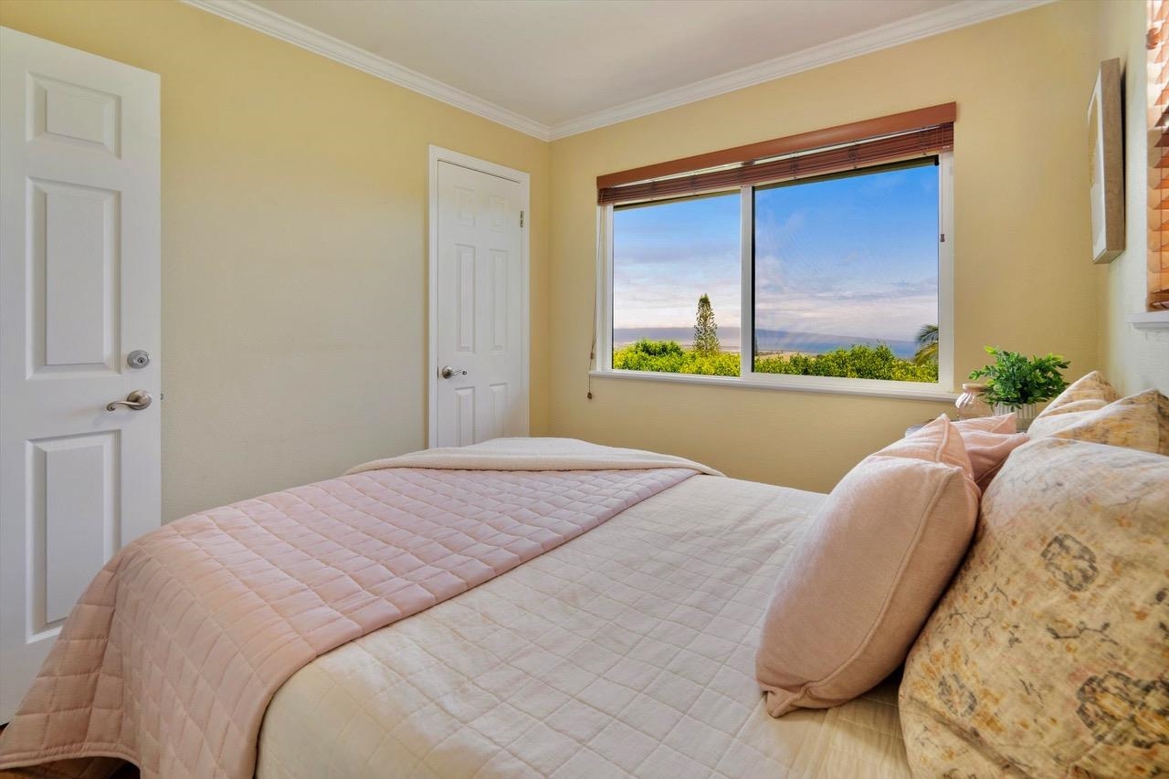 1115 Pookela Road Makawao, HI 96768 - Photo 22 of 37 a bedroom with a bed and a window