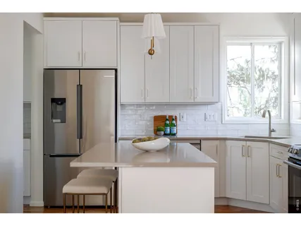 a kitchen with stainless steel appliances granite countertop a refrigerator and a sink