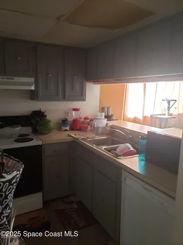 a kitchen with a sink and cabinets