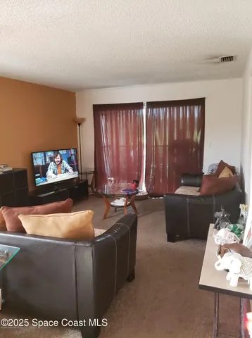 a room with furniture and a flat screen tv