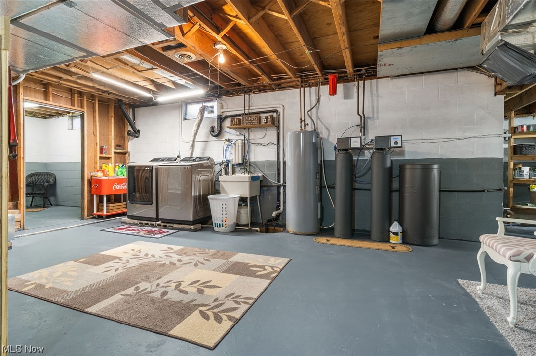 4398 Plymouth Springmill Road Shelby, OH 44875 - Photo 29 of 34 Basement with electric water heater and washing machine and dryer