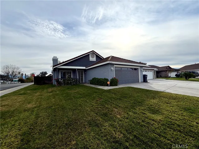 a aerial view of a house next to a big yard and large trees