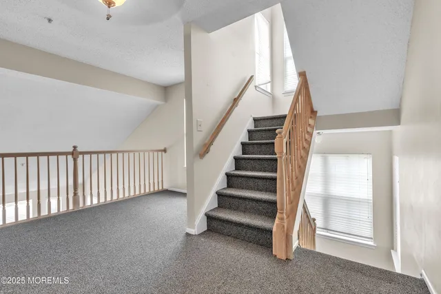 a view of staircase with white walls