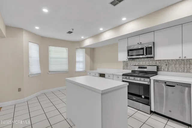 a kitchen with a stove a sink and a microwave