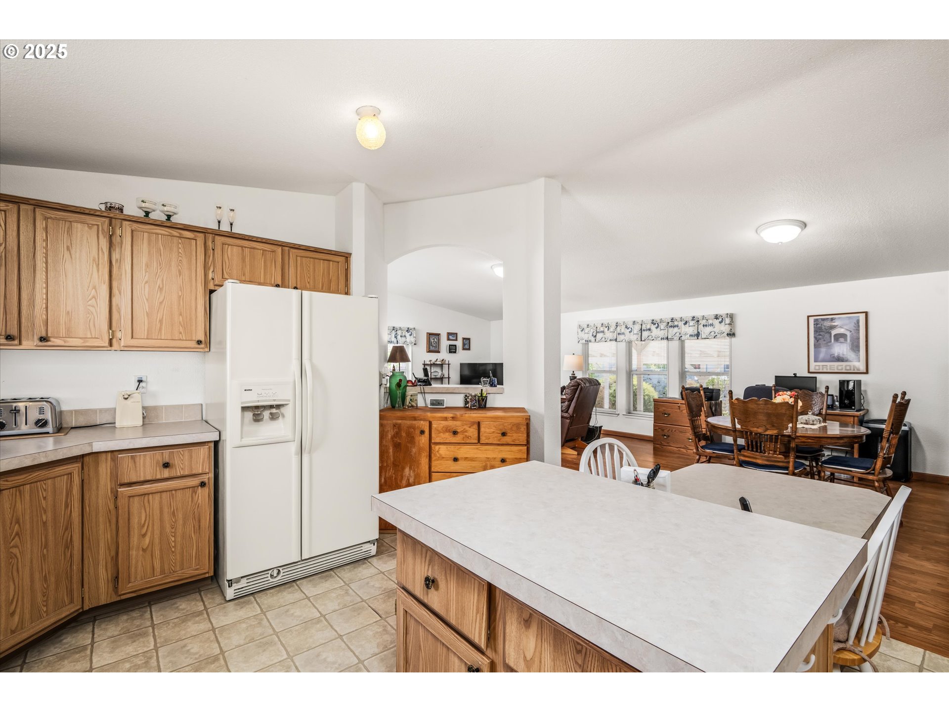 2668 Maia Loop Springfield, OR 97477 - Photo 15 of 28 a very nice looking open kitchen with stainless steel appliances granite countertop a refrigerator oven a sink dishwasher and white cabinets with wooden floor