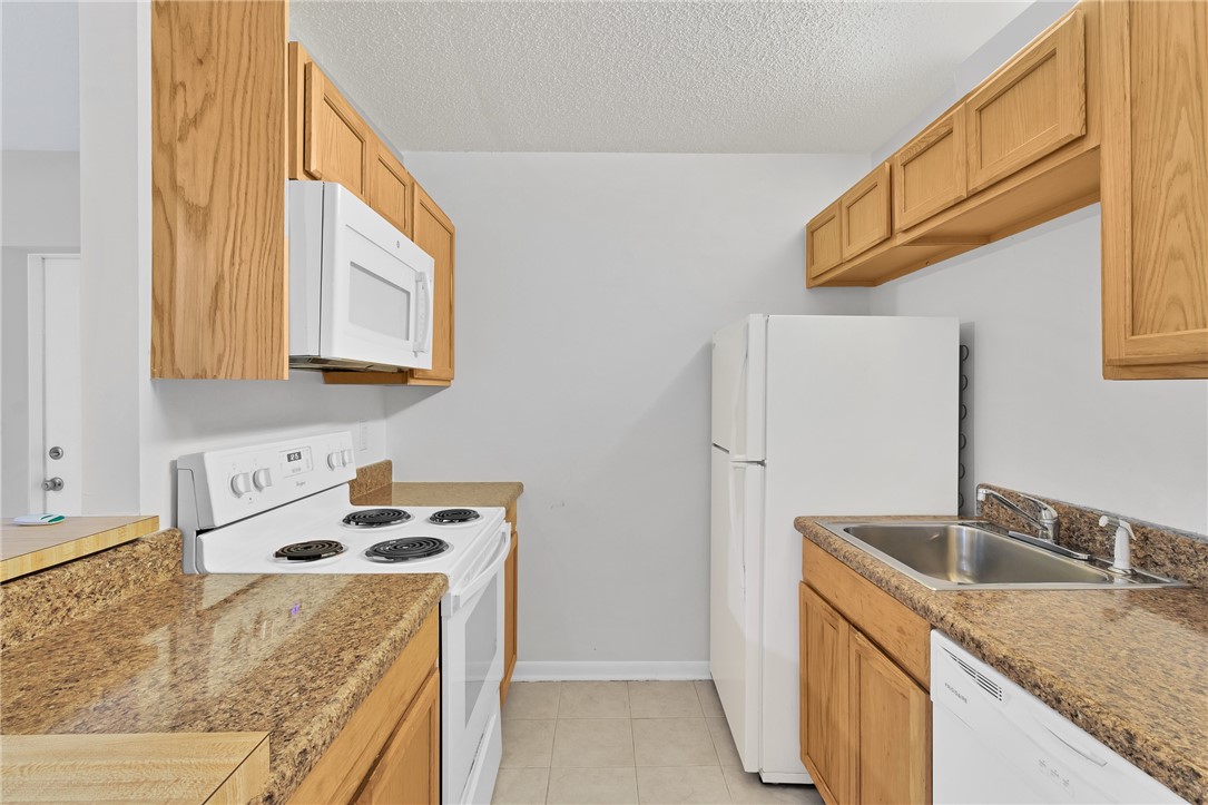 1136 Breezy Way, Unit 3B Sebastian, FL 32958 - Photo 12 of 34 a kitchen with a sink stove and cabinets