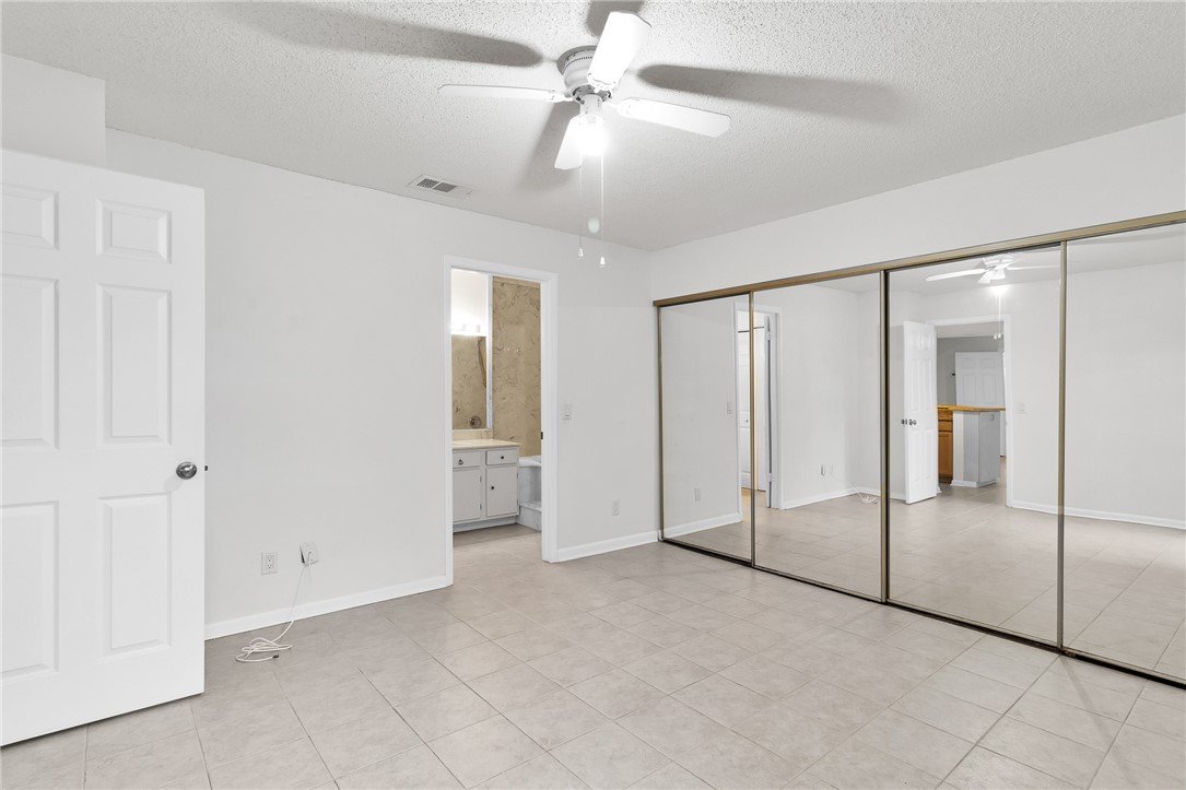 1136 Breezy Way, Unit 3B Sebastian, FL 32958 - Photo 14 of 34 an empty room with fan and glass door