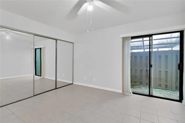 a view of an empty room with sliding glass door