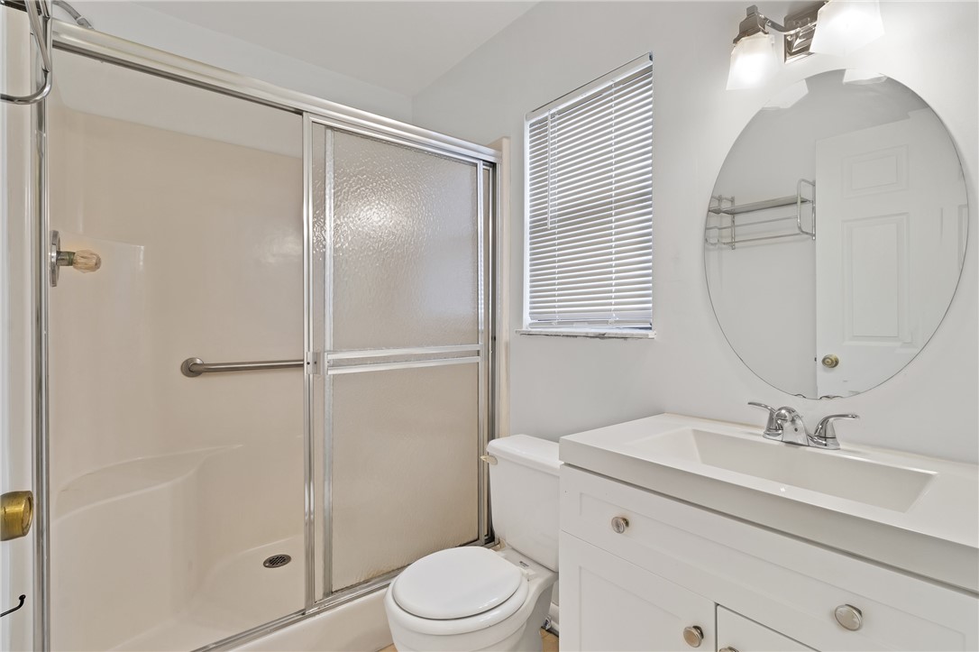 1136 Breezy Way, Unit 3B Sebastian, FL 32958 - Photo 18 of 34 a bathroom with a sink a toilet and shower