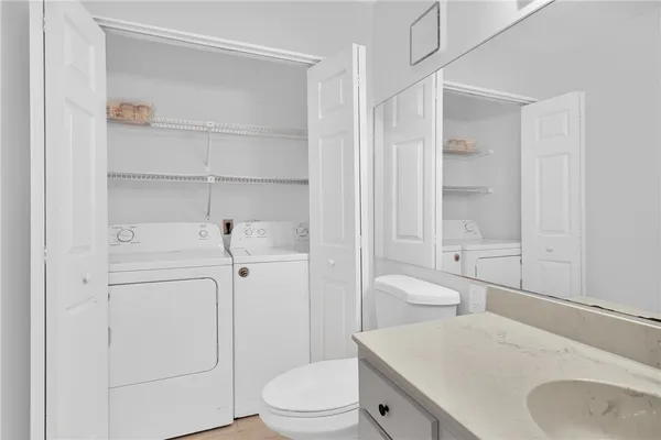 a bathroom with a sink toilet vanity and tub