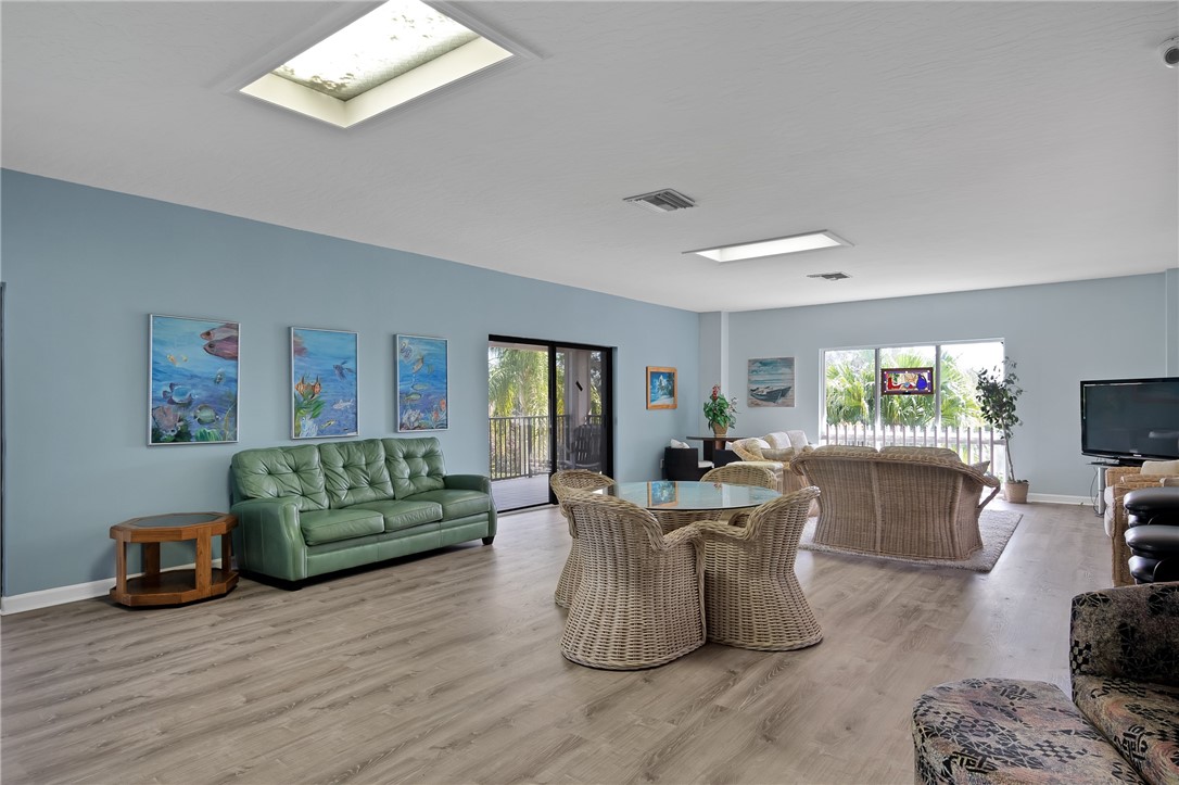 1136 Breezy Way, Unit 3B Sebastian, FL 32958 - Photo 31 of 34 a living room with furniture and a flat screen tv